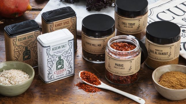 Various spice blends from Curio Spice Co. are seen on a kitchen counter