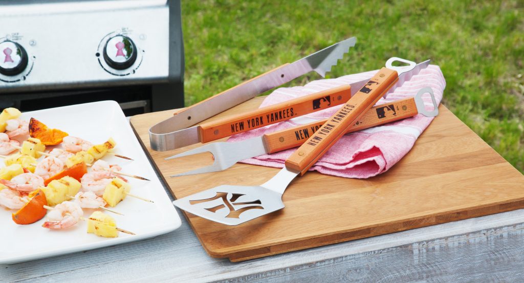 The ultimate New York Yankees fan shows off their team pride while grilling skewers with Sportula's 3 piece BBQ tool set