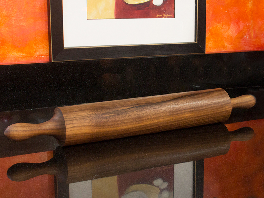 A handcrafted shaker rolling pin from Vermont Rolling Pins rests on a counter