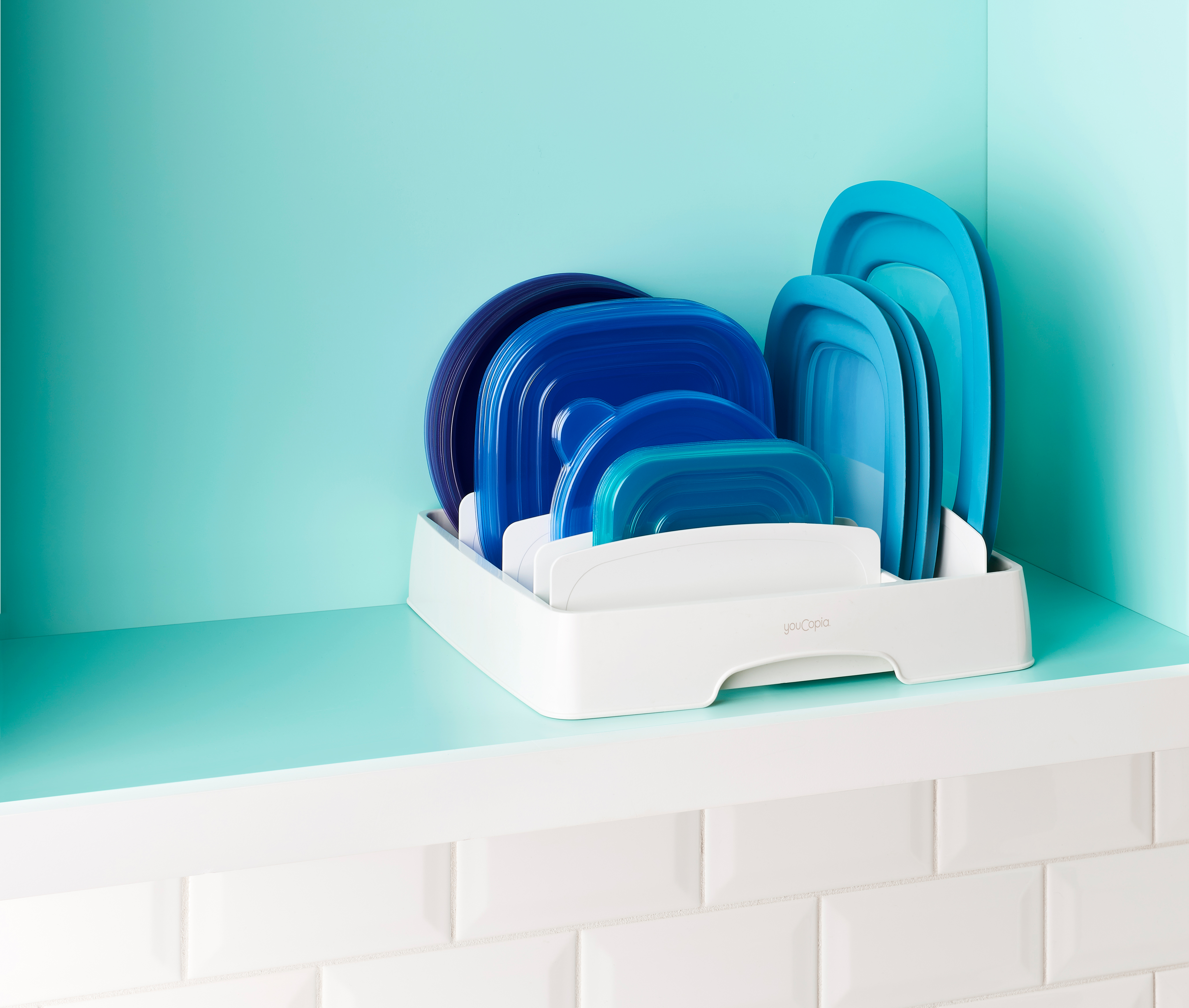 Plastic food container lids are organized neatly with YouCopia's Storalid lid organizer