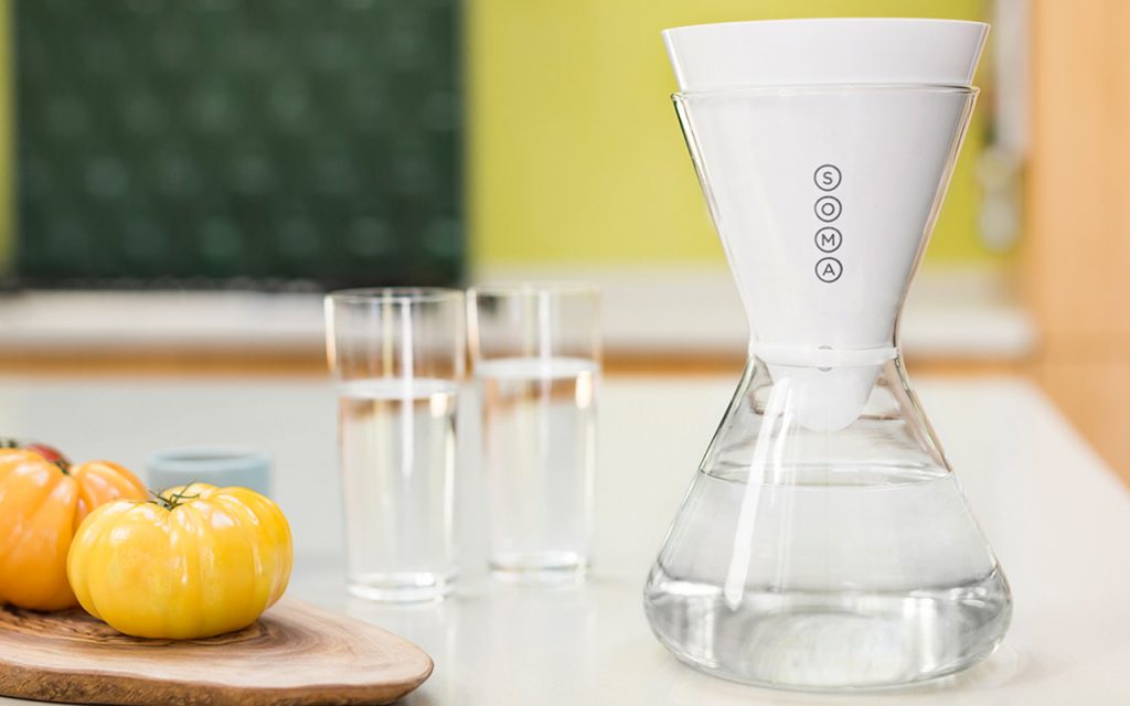 Water sits in a Soma water filtration carafe on a kitchen counter