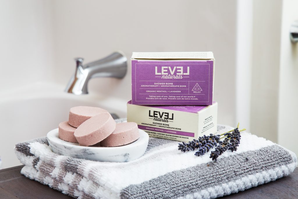 Lavender shower bombs from Level Naturals sit alongside a tub shower