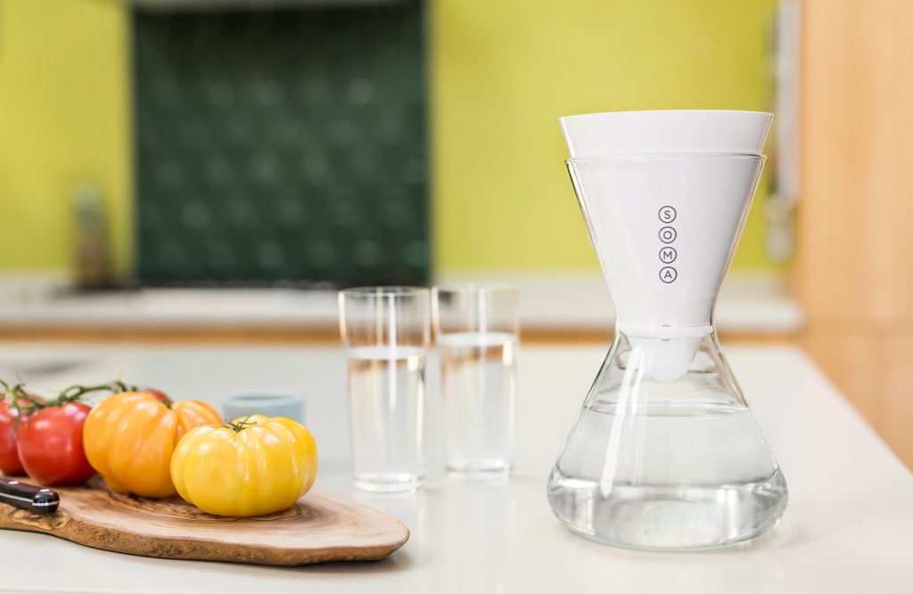 Water sits in a Soma water filtration carafe on a kitchen counter