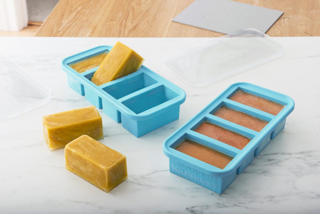 Cubes of chicken stock are seen frozen in Souper Cubes silicone freezer trays