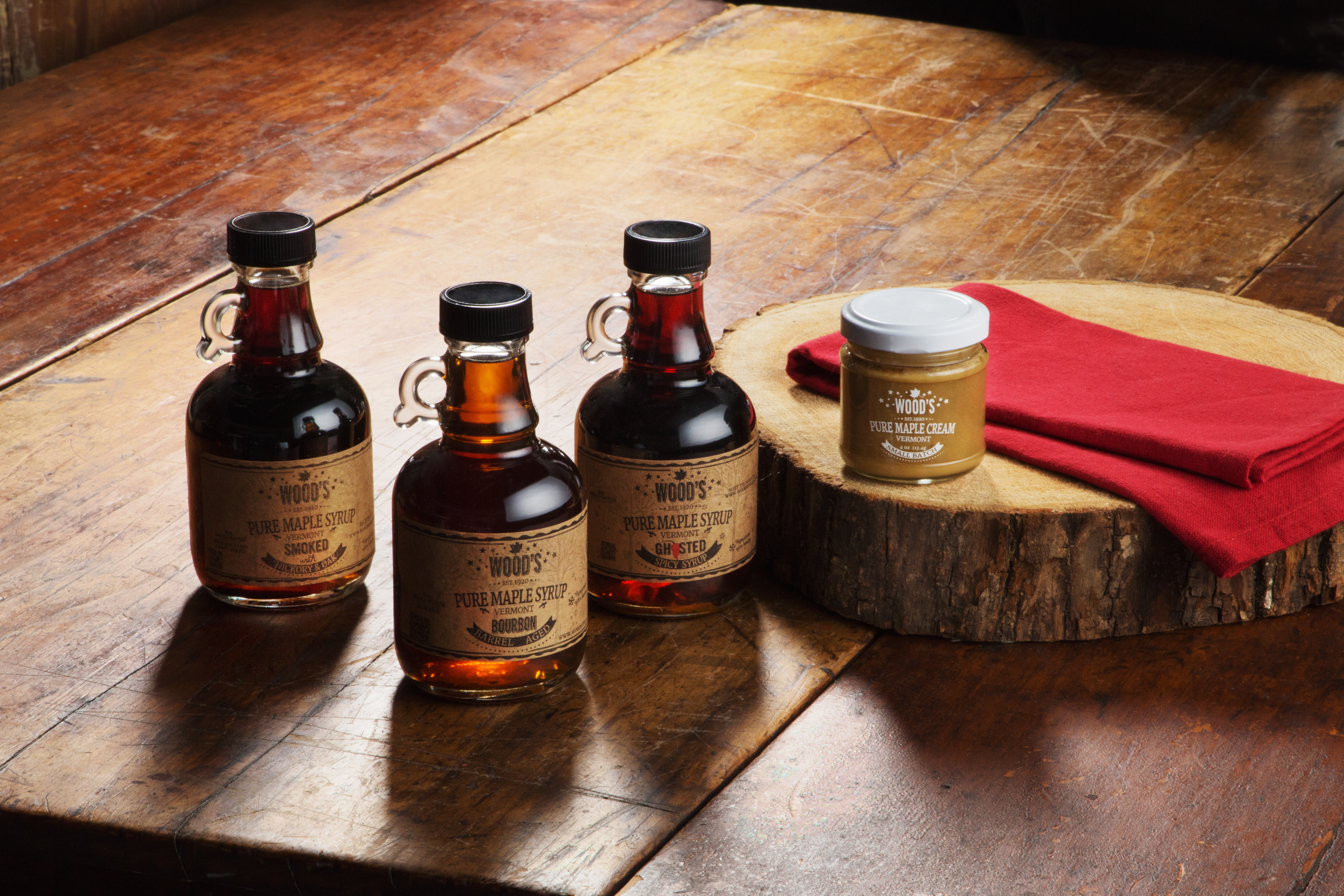Bottles of pure maple syrup & maple cream from Wood's Maple Syrup sit on a kitchen counter