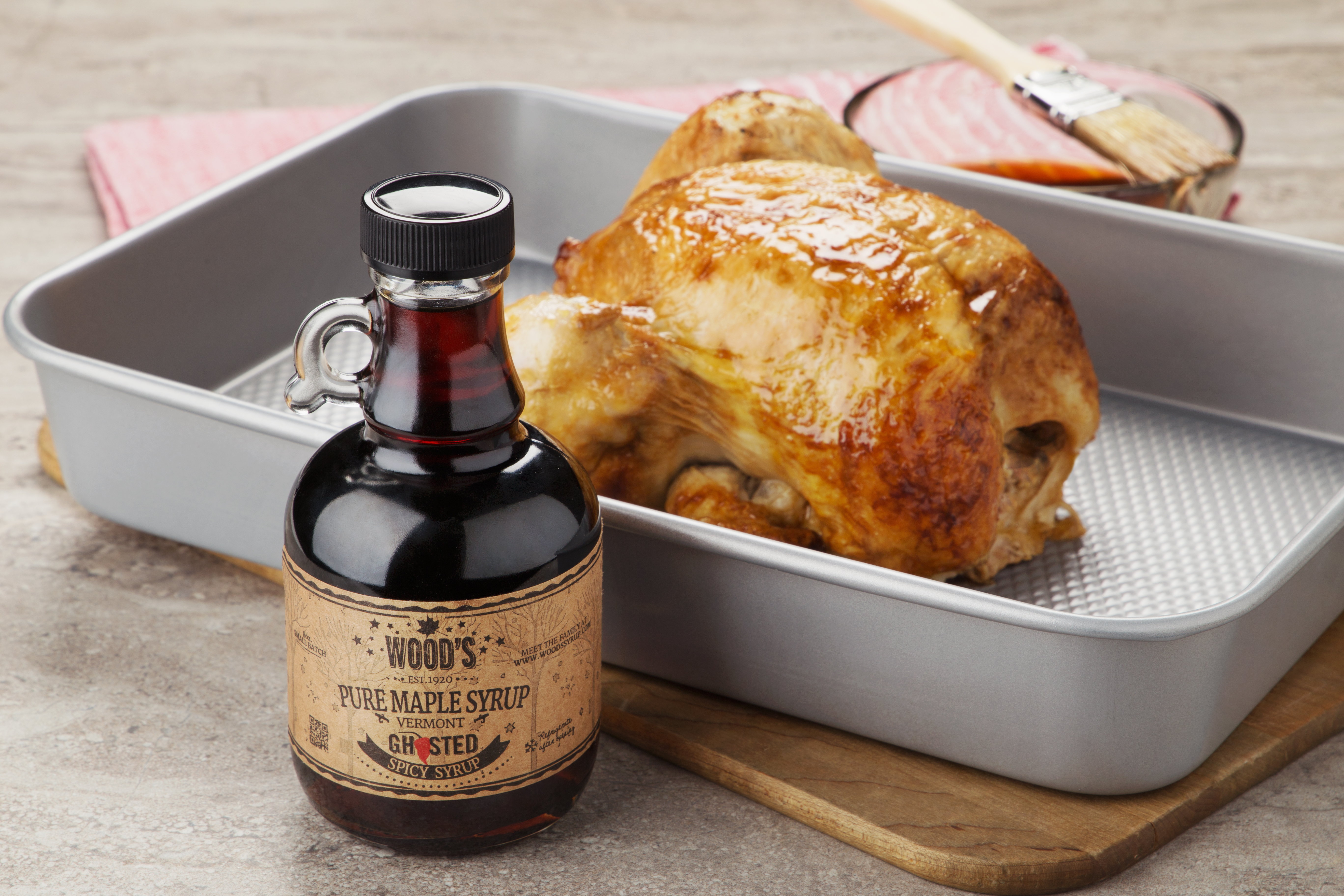 A bottle of ghost pepper infused maple syrup from Wood's Maple syrup sits next to a roasted turkey