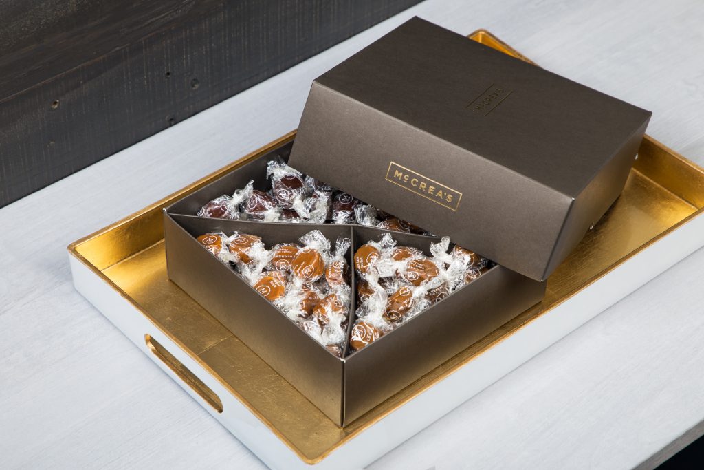 A party box of assorted artisanal caramels from McCrea's Candies lays on a table