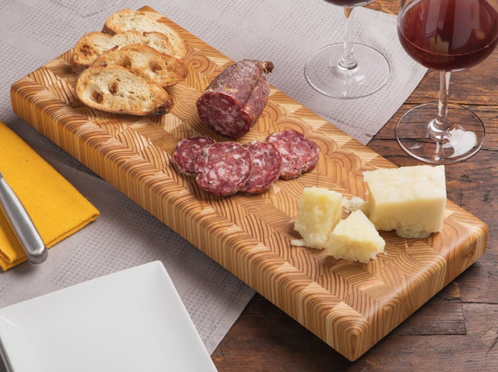 Charcuterie are sliced on an end grain double cheese board from Larch Wood 