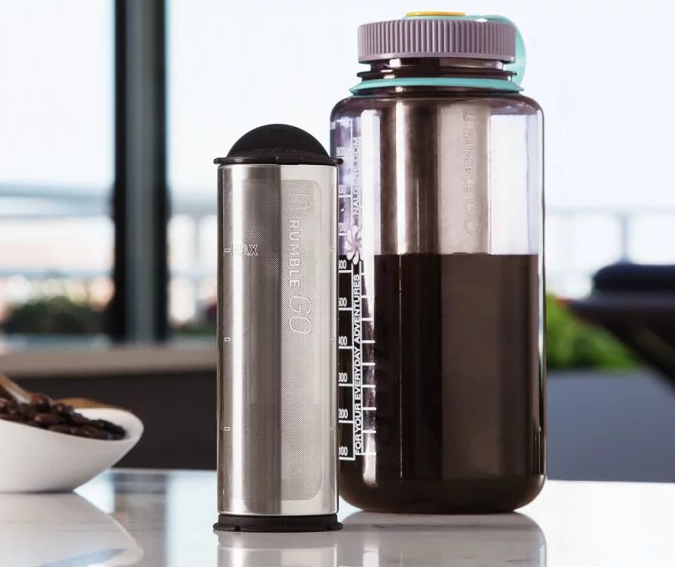 Fresh cold brew is seen made in a wide-mouth water bottle with a Rumble Go universal cold brew coffee filter next to it